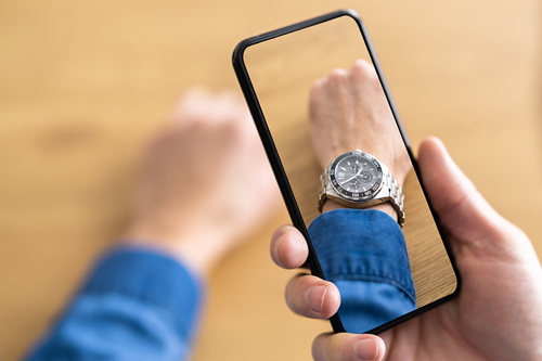 Man looking at a watch on his wrist image