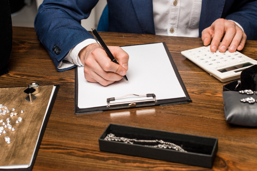 Businessman writing on notepad image