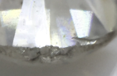 a diamond with indented naturals in the girdle and a cavity in the pavilion/girdle IMAGE